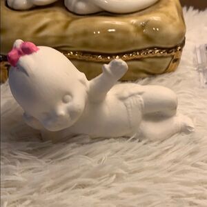 Kewpie Ceramic with bow laying down ceramic figure